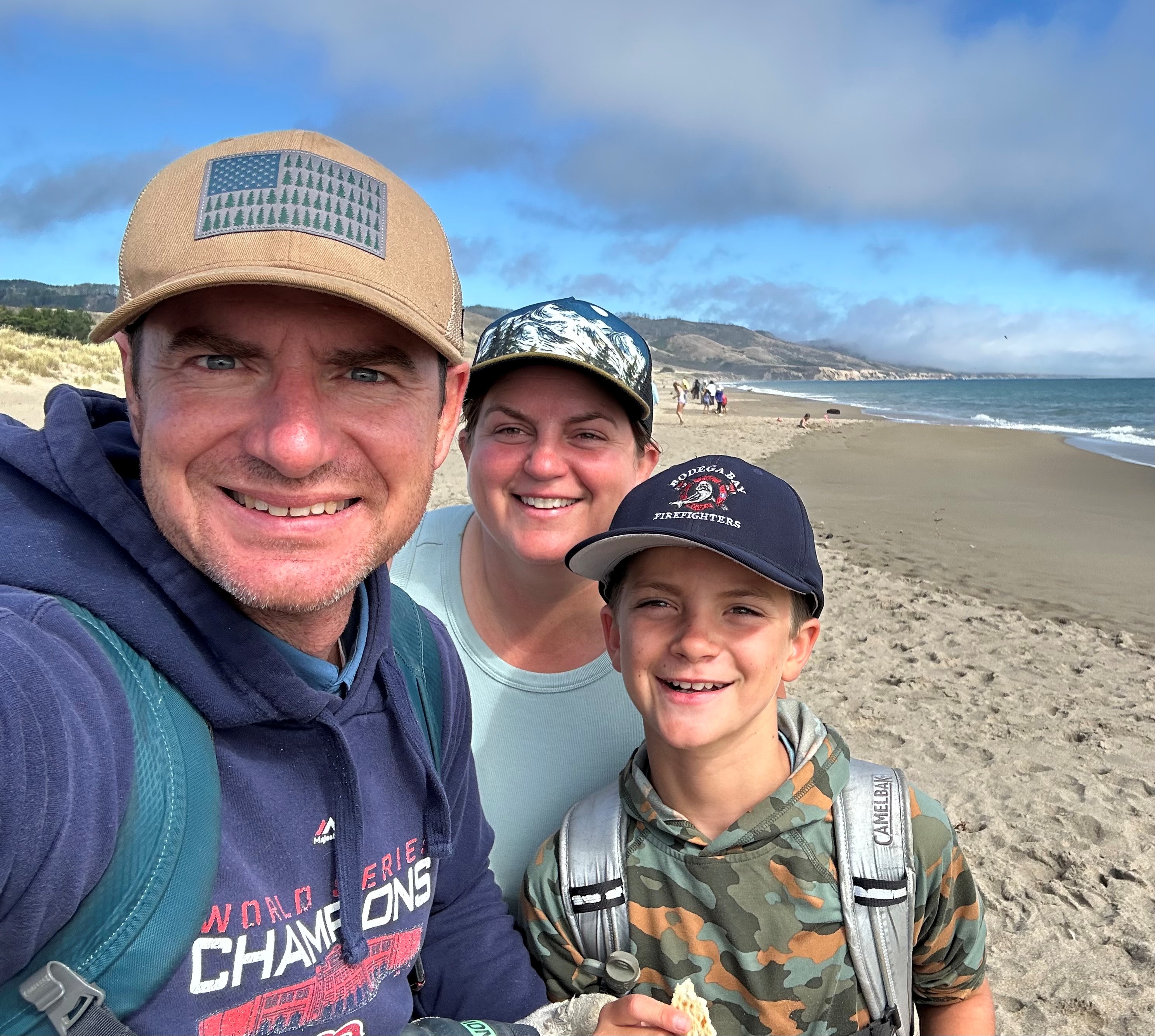 Eric Paulantonio poses for a selfie with his family on the beach