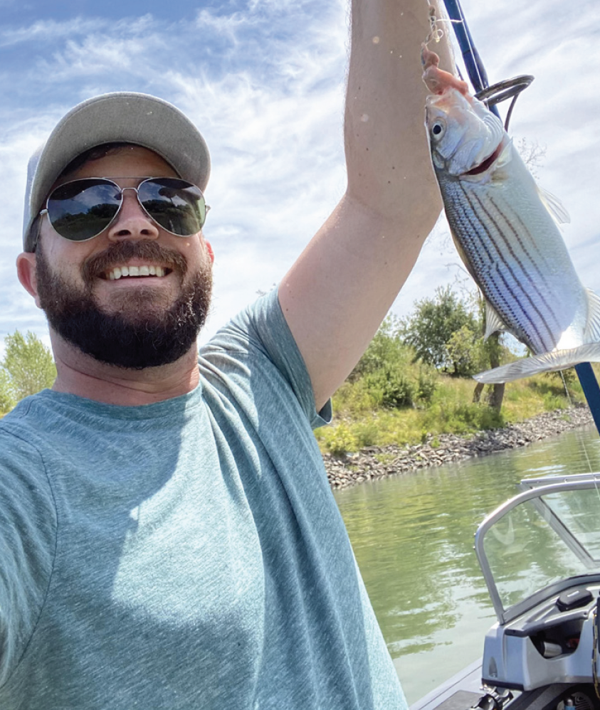 Justin Hall showing a fish that he caught