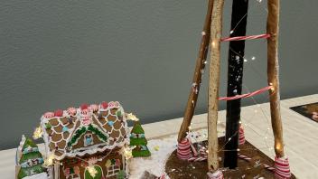 Ginger bread house and UC Davis water tower constructed out of baked goods and candy