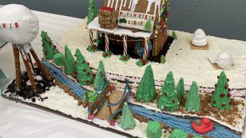 Scene including the Putah Creek Lodge, a bridge over the Arboretum Waterway and a UC Davis water tower, constructed from gingerbread and other sweets