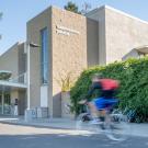 People bike past the Transportation Building