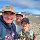 Eric Paulantonio poses for a selfie with his family on the beach
