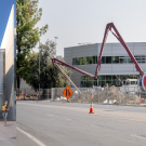 Graphic with rendering of Resnick Center and photo of construction on Hutchison Drive