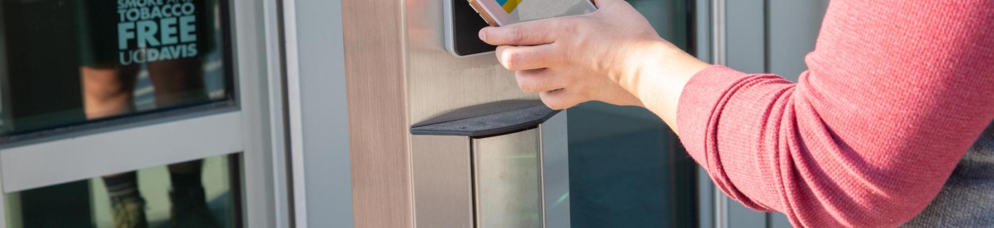 Person presenting mobile credentials to a card reader