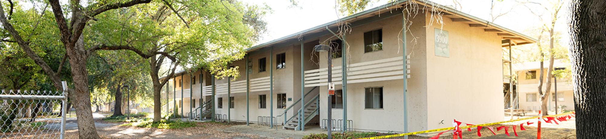 Image of Solano Park Housing complex with yellow, do-not-cross tape in front.
